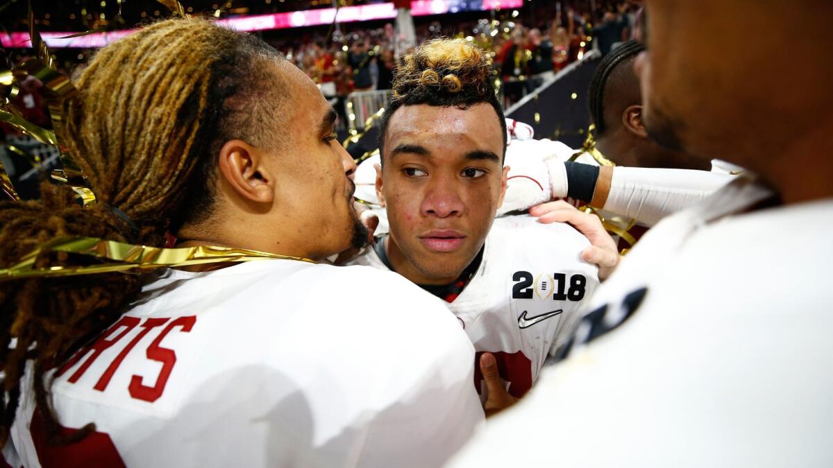 Alabama's Tua Tagovailoa, right, celebrates with teammate Jalen Hurts after beating Georgia to win the College Football Playoff national championship in Atlanta on Jan. 8.