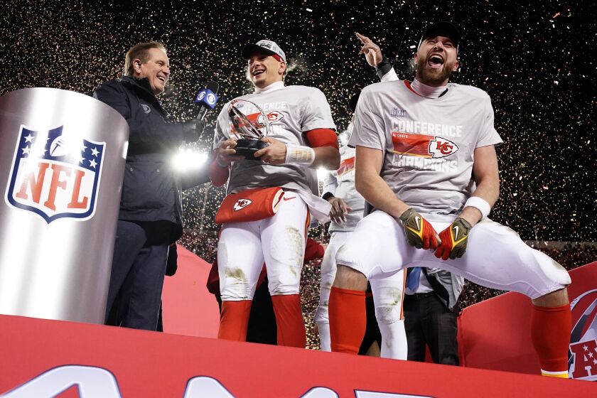 Kansas City Chiefs quarterback Patrick Mahomes and tight end Travis Kelce, right, celebrate with the Lamar Hunt Trophy after the NFL AFC Championship playoff football game against the Cincinnati Bengals, Sunday, Jan. 29, 2023, in Kansas City, Mo. The Chiefs won 23-20. (AP Photo/Charlie Riedel)