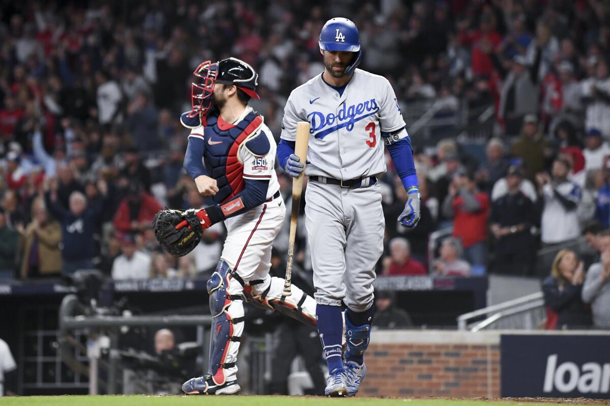 Chris Taylor walks off the field after striking out in the third inning for the Dodgers.