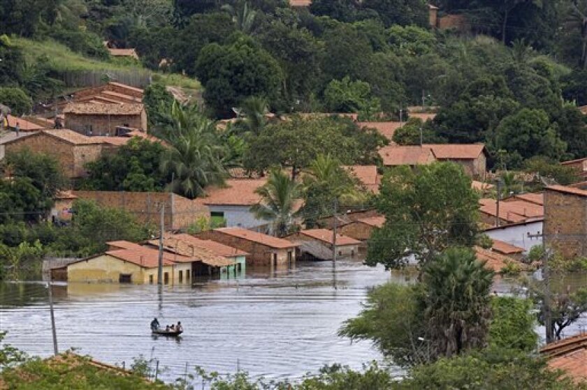 Residents row a boat on a flooded street in Pedreiras, Maranhao state, Brazil, Sunday, May 10, 2009. Across a vast swath of the country, flooding has killed 40 and forced nearly 300,000 Brazilians from their homes.(AP Photo/Andre Penner)