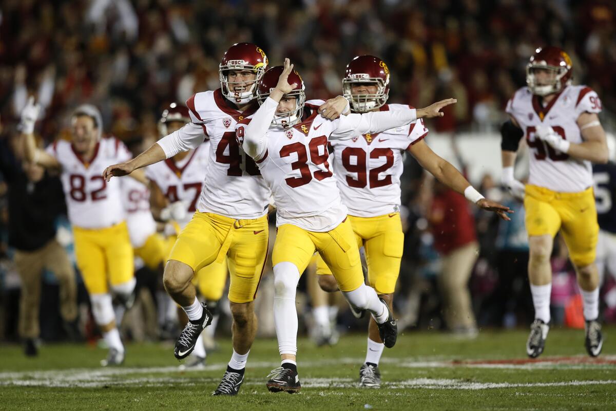 USC placekicker Matt Boermeester, 39, celebrates with holder Wyatt Schmidt after making a game-winning 46-yard field goal as time expired to beat Penn State 52-49 in the Rose Bowl Game.