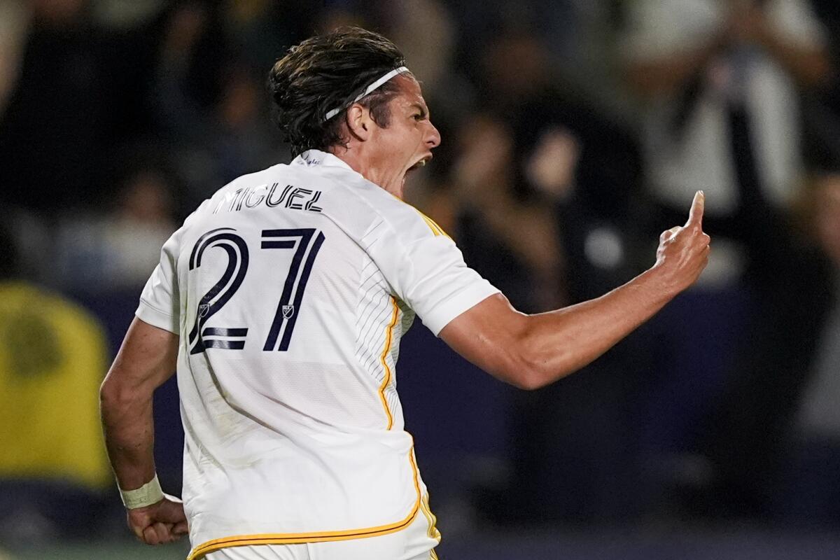 Galaxy forward Miguel Berry cheers and holds up an index finger.