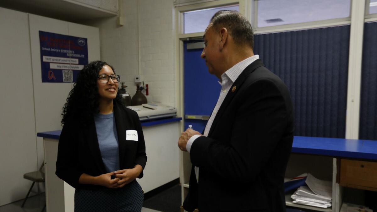 Miriam Lizeth Tellez Sorrosa, 22, of Fullerton, left, and Rep. Gil Cisneros (D-Yorba Linda) speak before a town hall meeting at Los Altos High School over the weekend. Sorrosa will attend the State of the Union address Tuesday as a guest of Cisneros.