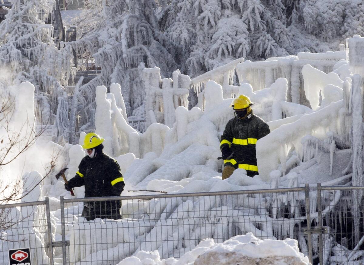 Extreme cold encrusts the charred rubble of a seniors home in the Quebec town of L'Isle-Verte in thick ice, hampering the search for survivors or remains of the 30 elderly residents listed as missing after a fire.