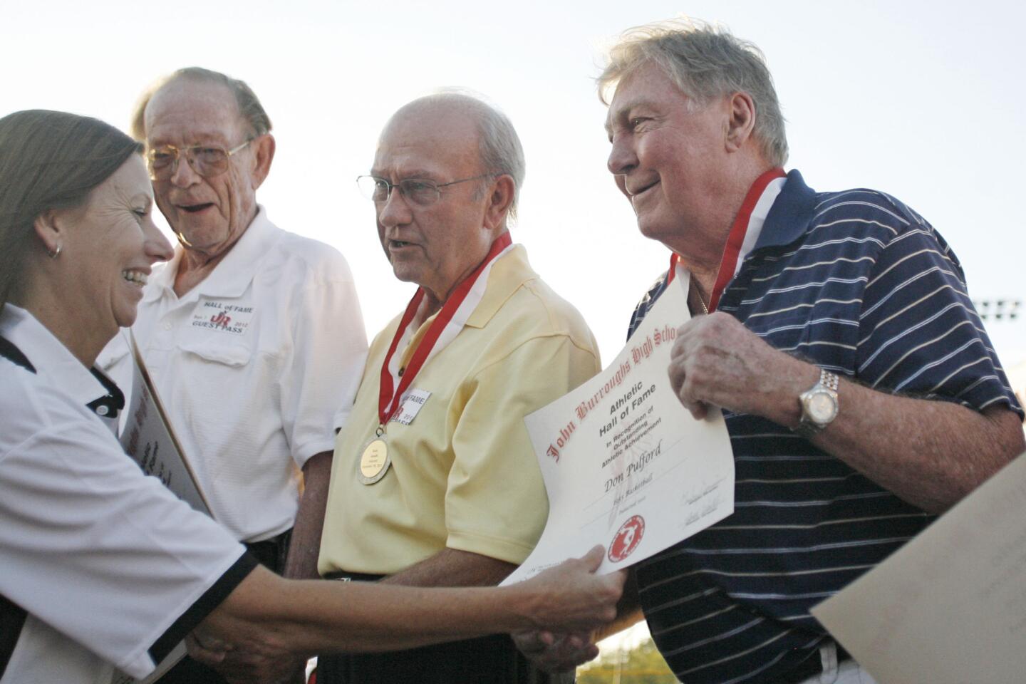 Inductee Dom Pufford, right, is honored into the Hall of Fame at John Burroughs High School in Burbank on Friday, September 7, 2012.