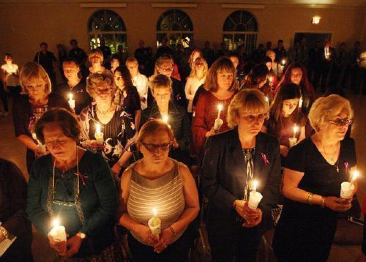 Attendees share a moment of silence during the annual Domestic Violence Candlelight Vigil held at the YWCA.