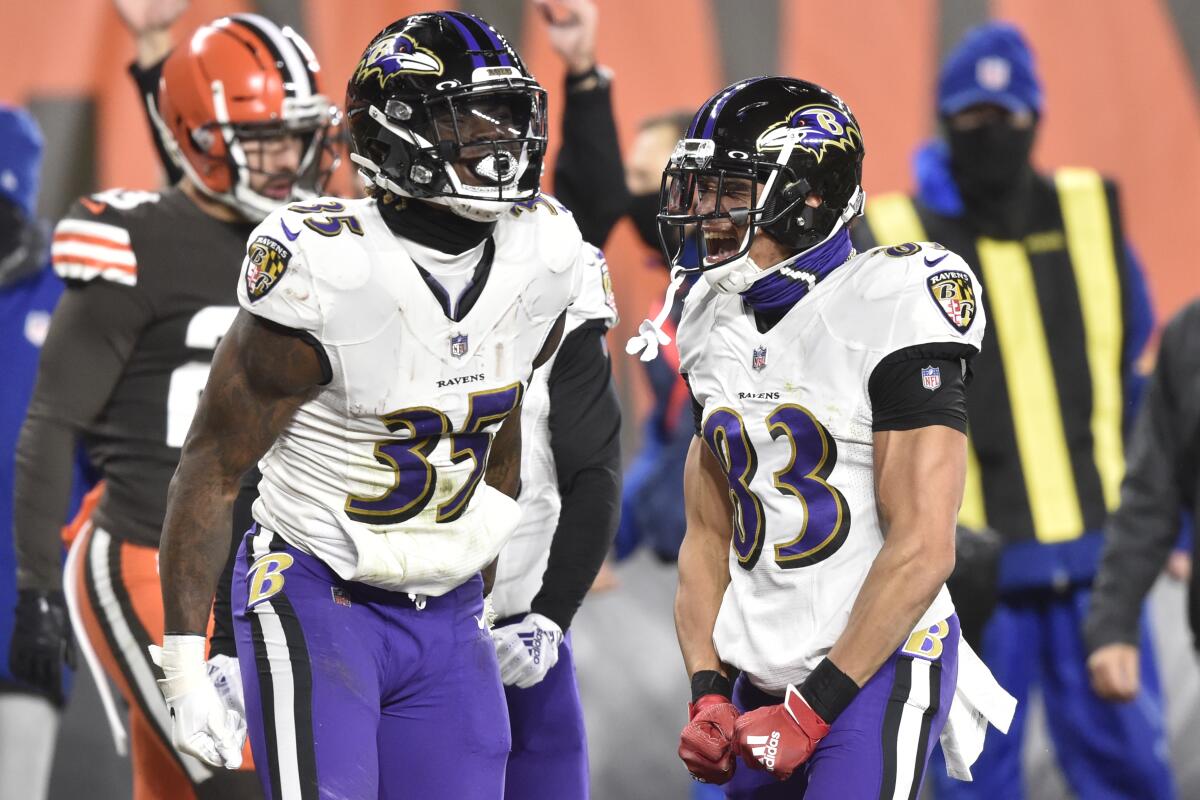 Baltimore Ravens running back Gus Edwards (35) and wide receiver Willie Snead (83) celebrate a touchdown.