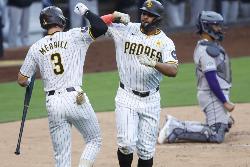 San Diego CA - May 13: San Diego Padres' Xander Bogaerts celebrates with Jackson Merrill after hitting a solo home run in the second inning against the Colorado Rockies at Petco Park on Monday, May 13, 2024 in San Diego, CA. (K.C. Alfred / The San Diego Union-Tribune)