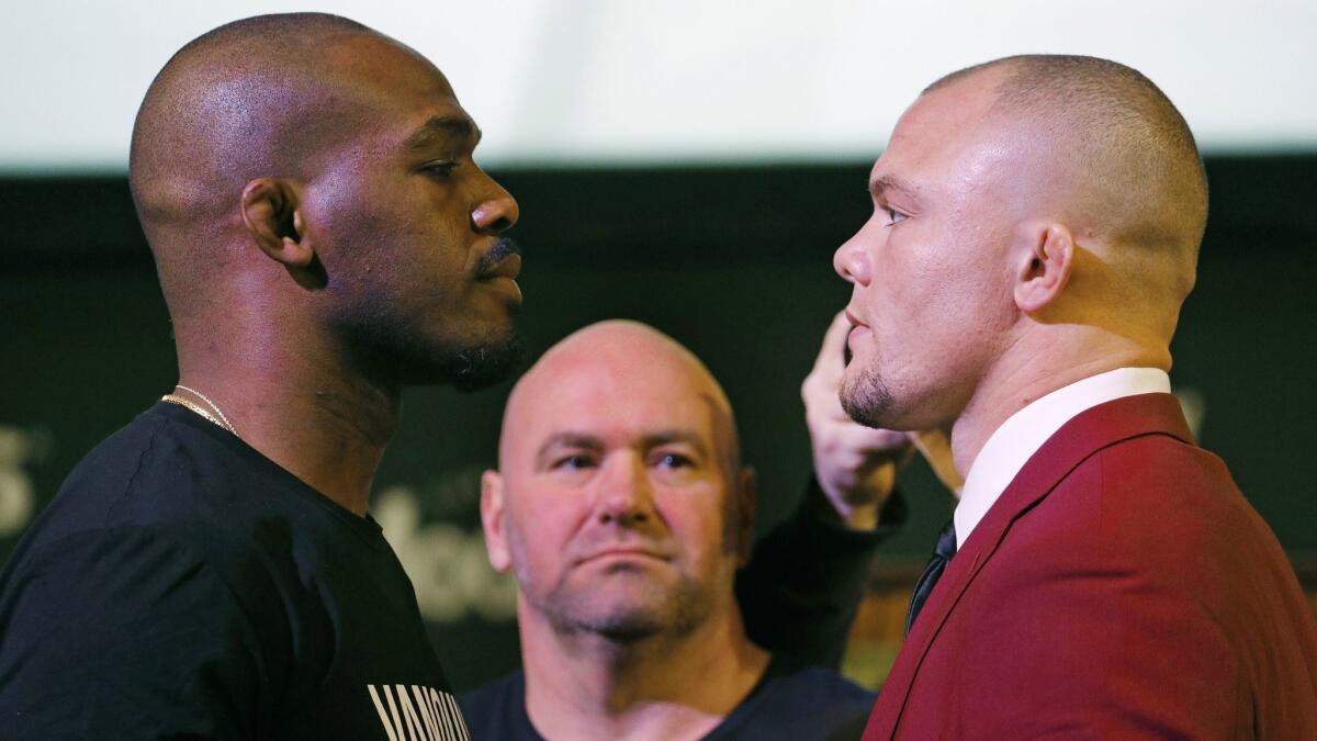 Jon Jones, left, and Anthony Smith stare each other down during a Jan. 31 news conference in Las Vegas for UFC 235.