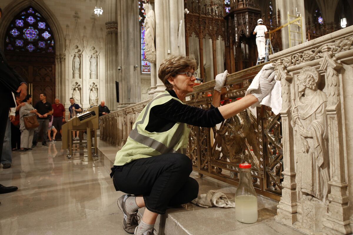 At St. Patricks Cathedral in New York, Lucia Popian, of New York, finished polishing the gold and bronze elements of St. Patricks Cathedral in preparation for Pope Francis' visit tomorrow. Popian was hired to work on the cathedral three years ago, before the Pope's visit was announced. "We love to have him here," says Lucia Popian.
