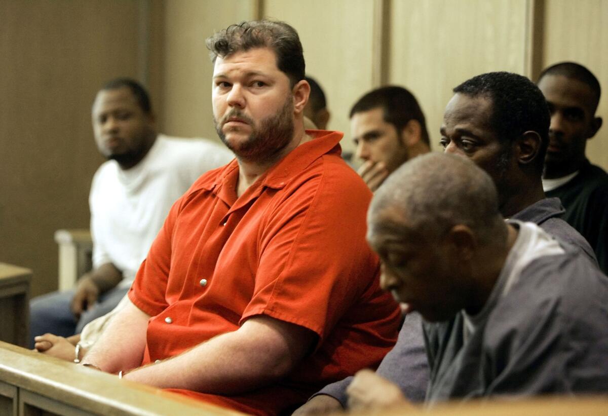 Former Oakland Raiders center Barret Robbins, left, awaits a hearing at the Miami-Dade courthouse in Miam on Sept. 23, 2005.