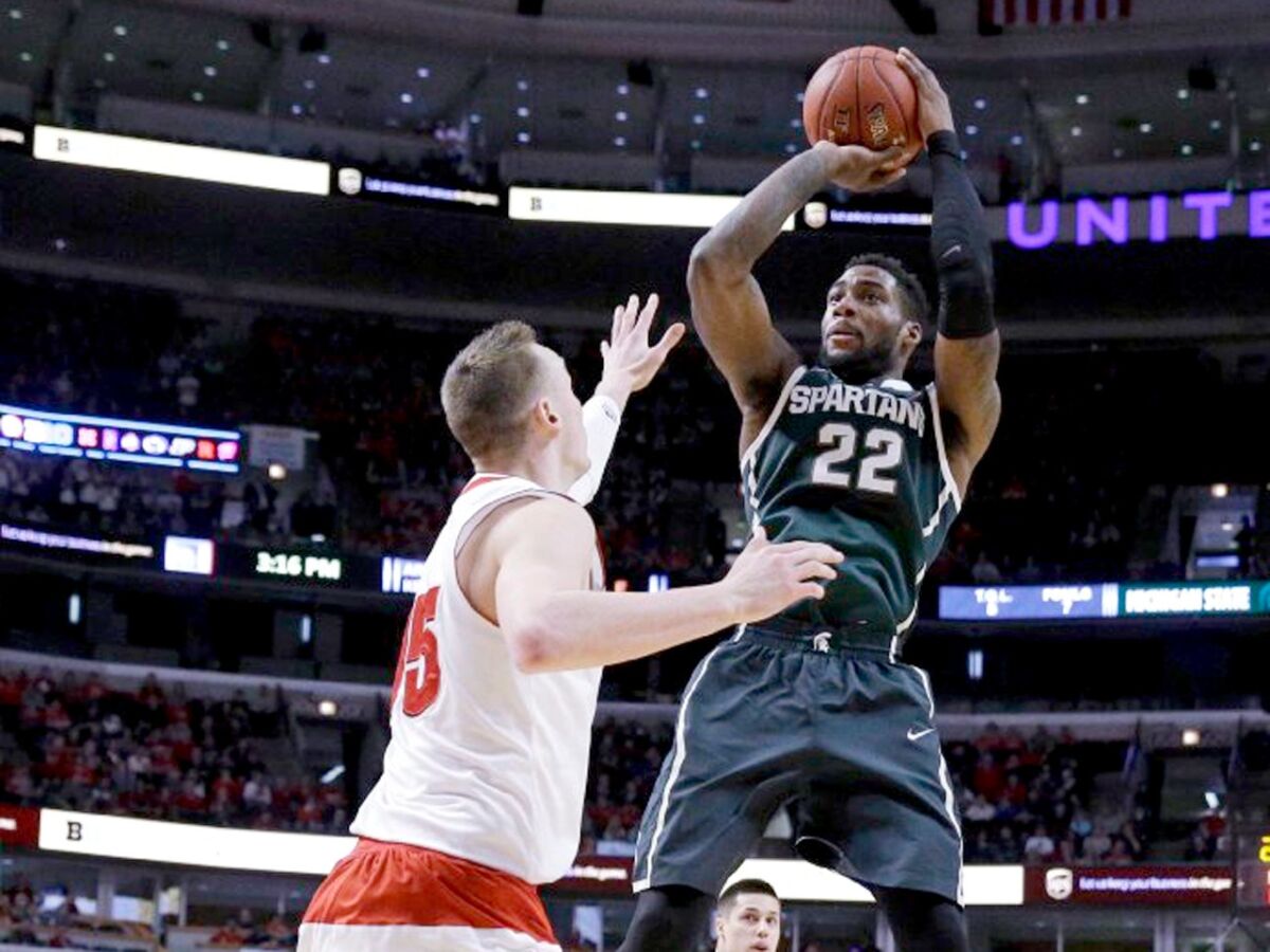 Michigan State's Brendan Dawson shoots over Wisconsin's Sam Dekker during the Big Ten Conference championship game on March 15.
