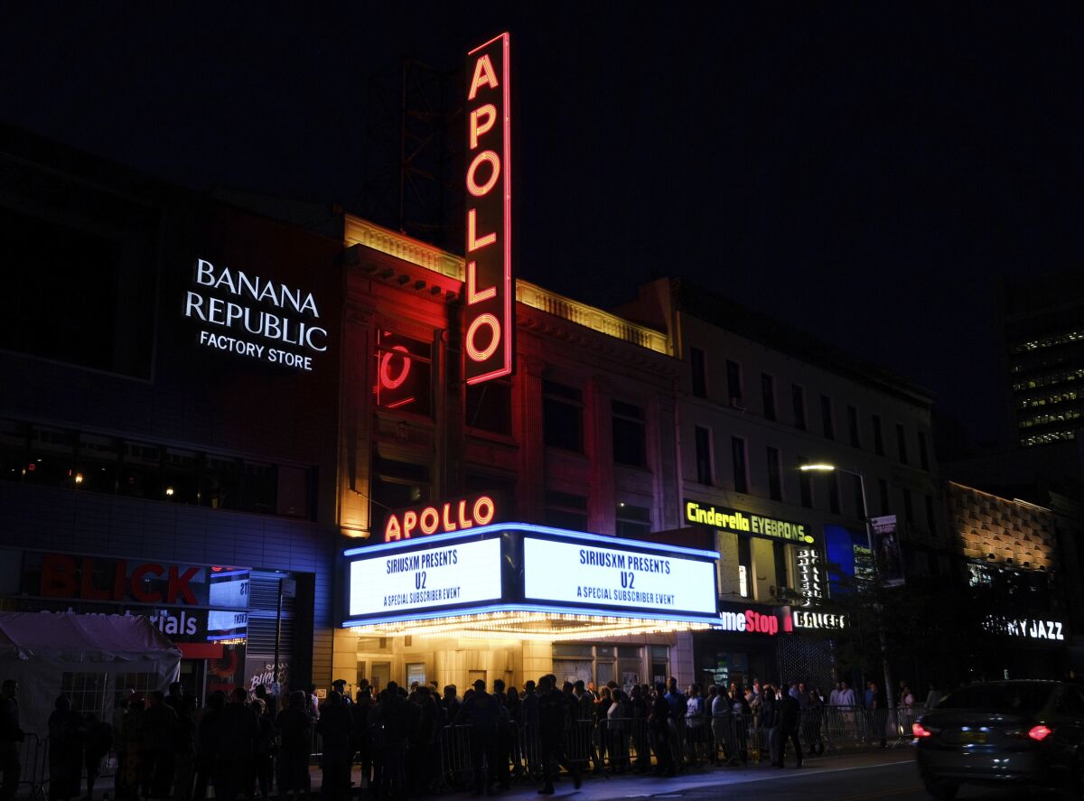 FILE - People line up at the Apollo Theater, the venue for the U2 SiriusXM concert in New York on June 11, 2018. BET announced that the 33rd annual Soul Train Awards, which honors the best in soul, hip hop and rhythm and blues music, will be taped at the Apollo and premiere on BET and BET Her on Sunday, Nov. 28. (Photo by Evan Agostini/Invision/AP, File)