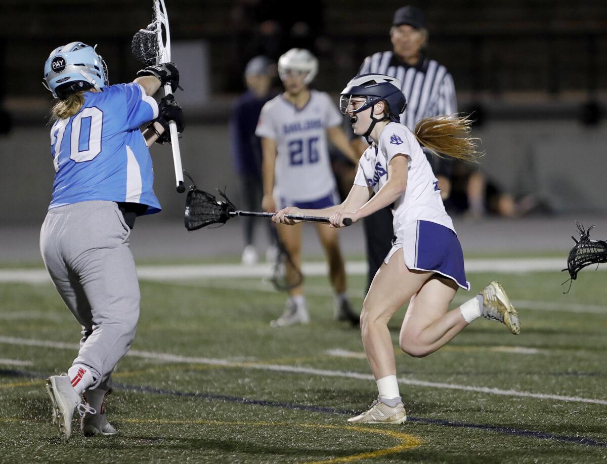 Newport Harbor's Rowdy Farmer, right, shoots and scores at close range during Battle of the Bay girls' lacrosse on Thursday.