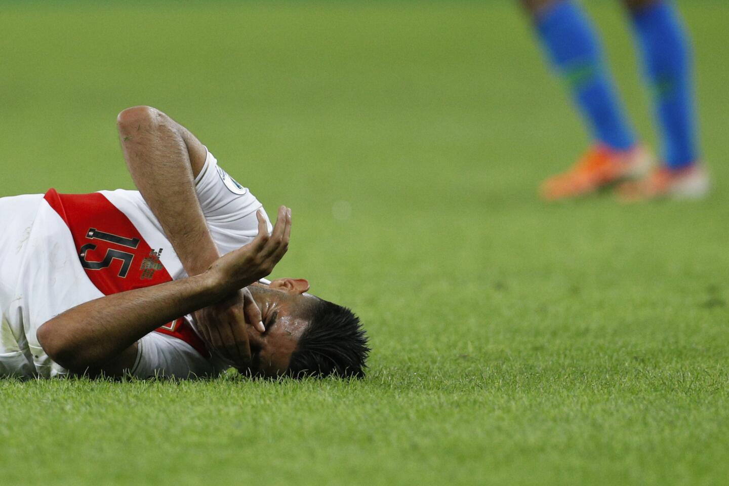 Peru's Carlos Zambrano reacts after colliding with Brazil's Gabriel Jesus during the final soccer match of the Copa America at the Maracana stadium in Rio de Janeiro, Brazil, Sunday, July 7, 2019.