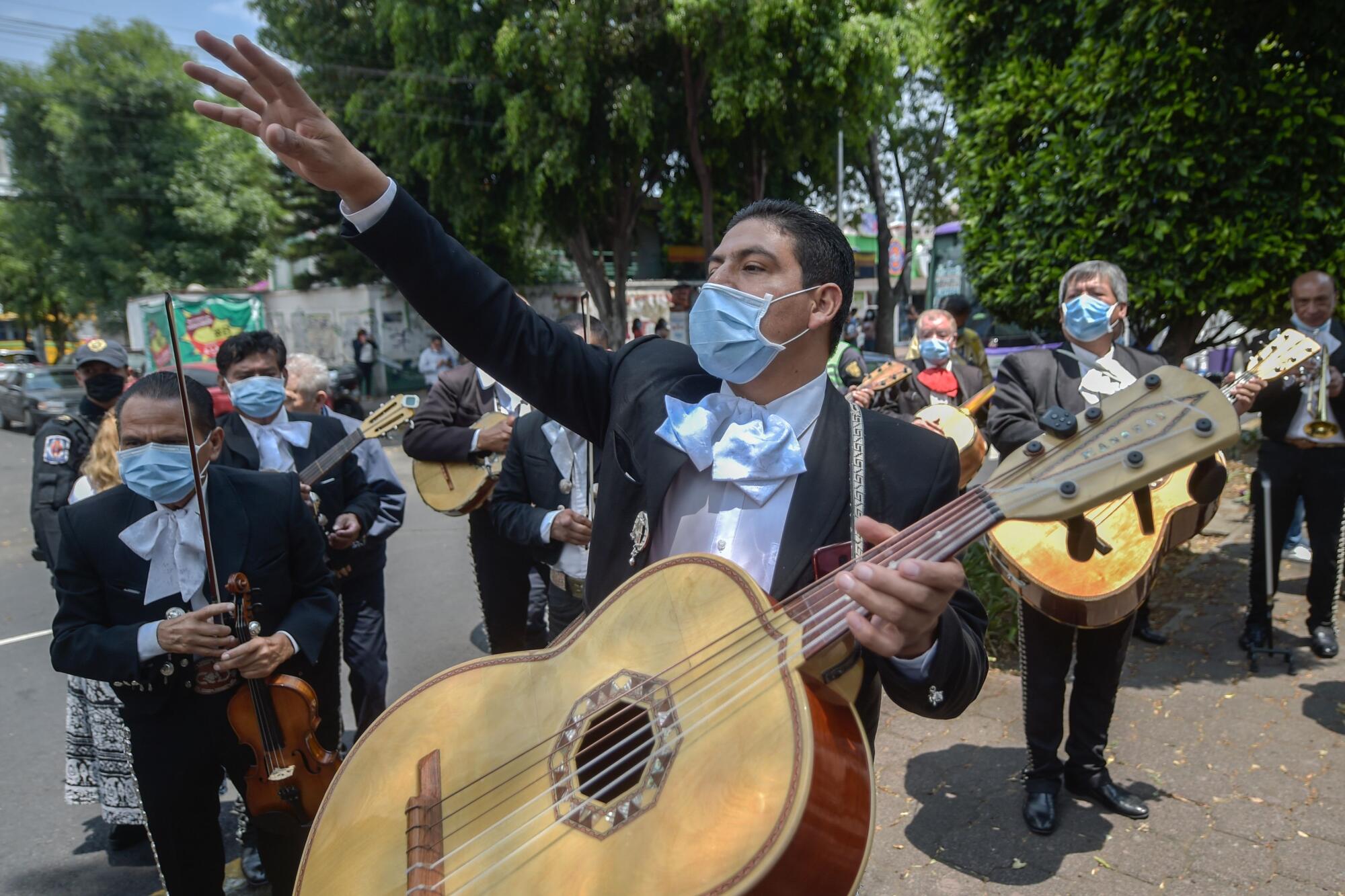 Masked mariachis serenade the National Institute of Respiratory Diseases in Mexico City on April 7 as a gesture of encouragement for COVID-19 patients and caregivers.