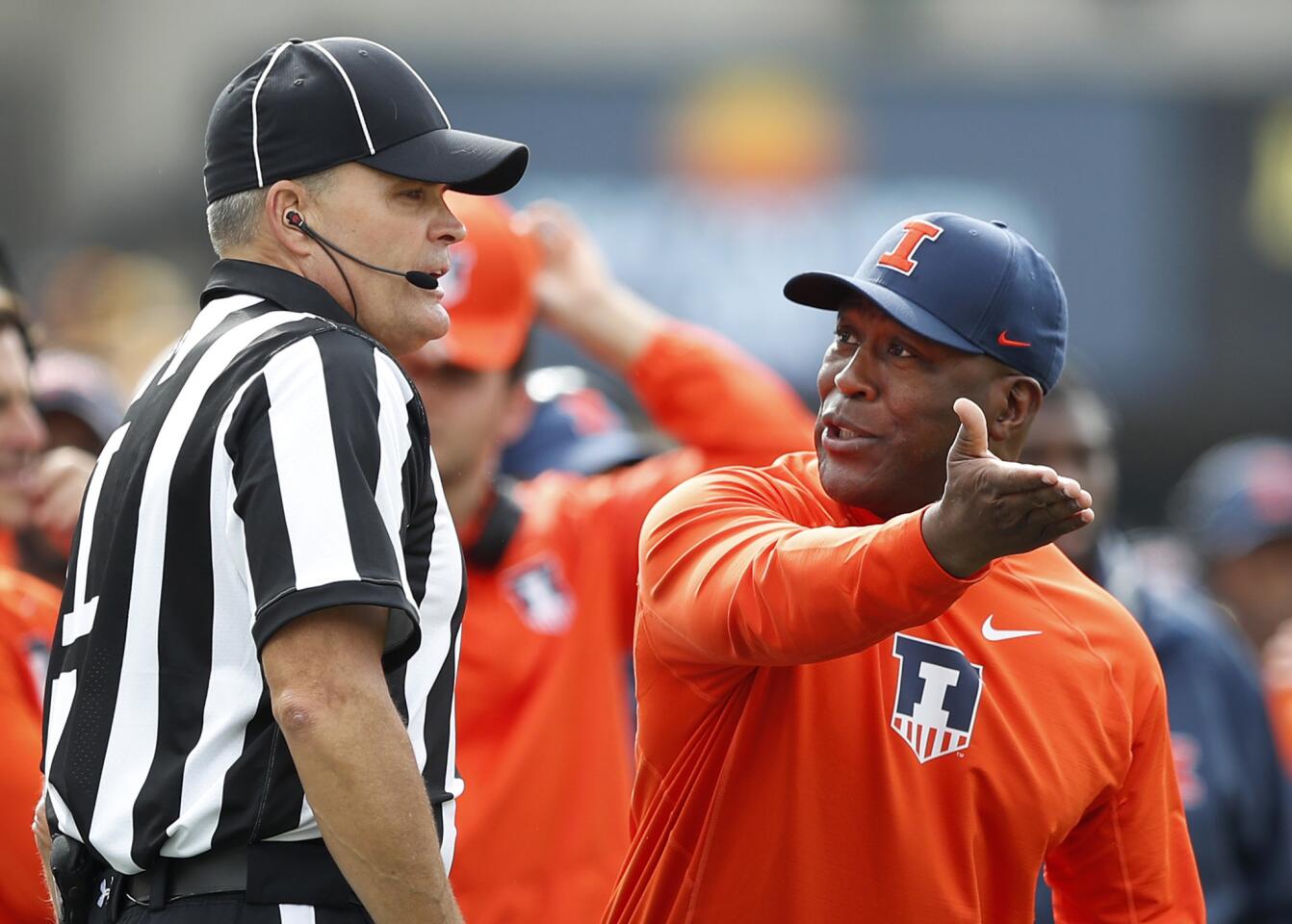 Illinois coach Lovie Smith, right, questions a call against his team during the first half against Iowa, Saturday, Oct. 7, 2017, in Iowa City, Iowa.