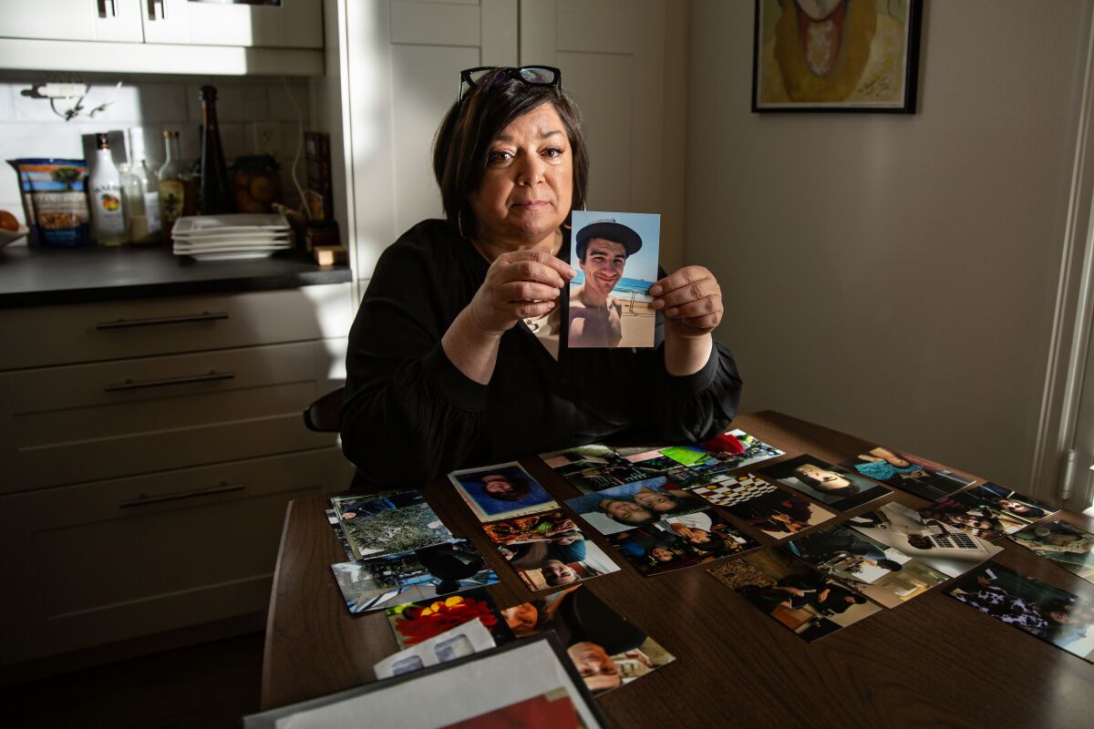 Deborah Smith holds a photo of her son Nicholas who is struggling with mental illness.