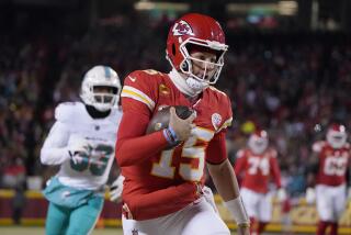 Kansas City Chiefs quarterback Patrick Mahomes (15) runs in front of Miami Dolphins cornerback Eli Apple during the first half of an NFL wild-card playoff football game Saturday, Jan. 13, 2024, in Kansas City, Mo. (AP Photo/Ed Zurga)