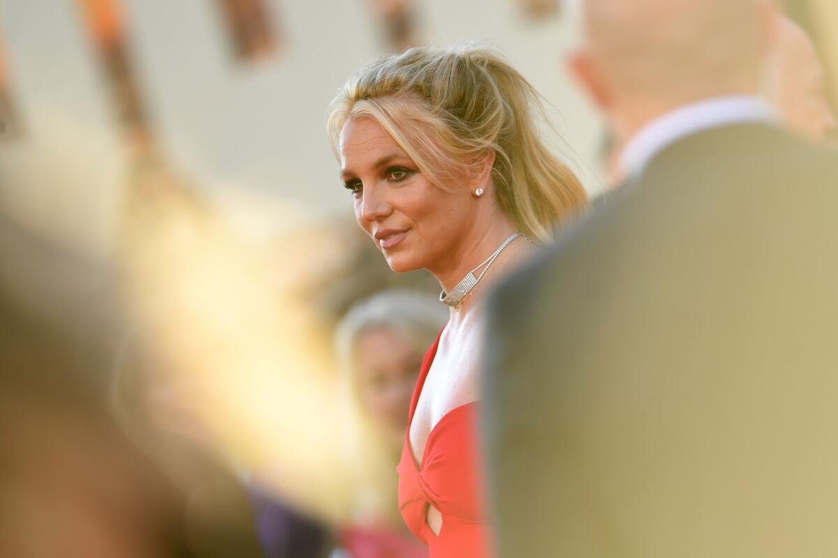 Britney Spears in the middle of a crowd at a Hollywood event