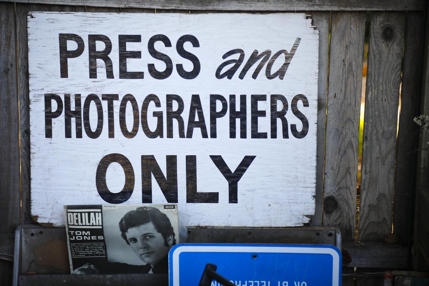 A press and photographers only sign and a Tom Jones record album are but two of the unique items at Lhooq Books, a funky vintage bookstore in Carlsbad Village. Sean Christopher, the owner recently received a 60-day eviction notice for both the shop and the adjoining house where he has raised his son, alone. He's hoping to achieve a stay of eviction on the property long enough to sell off his book inventory and find a new space without going bankrupt and ending up homeless with his son.