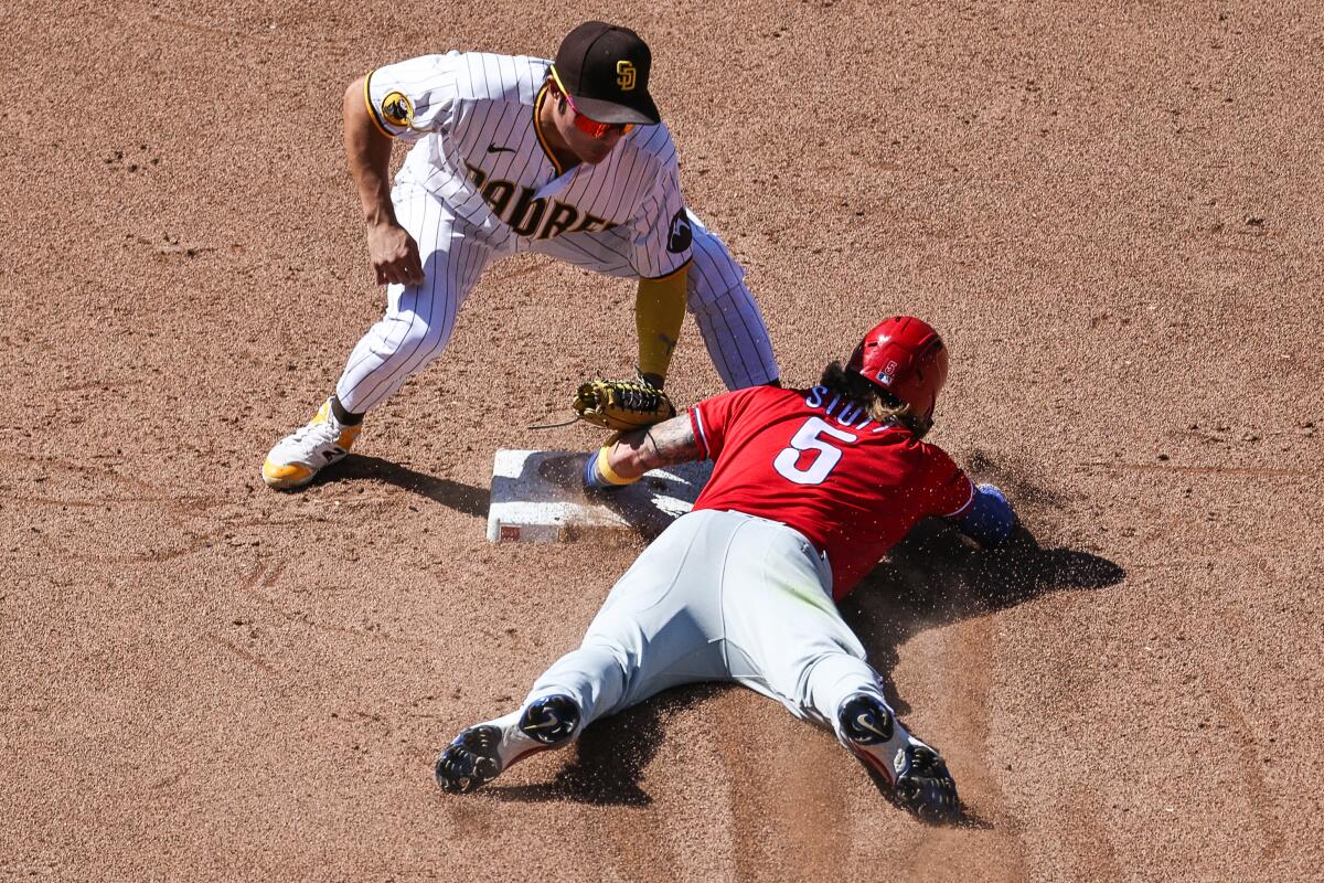 Padres second baseman Ha-Seong Kim (7) attempts to tag out Phillies second baseman Bryson Stott (5).