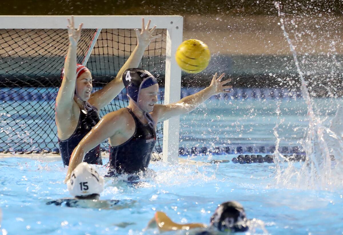 Newport Harbor's Morgan Netherton (4) and goalie Anna Reed block a shot during Wednesday's Open Division semifinal match.