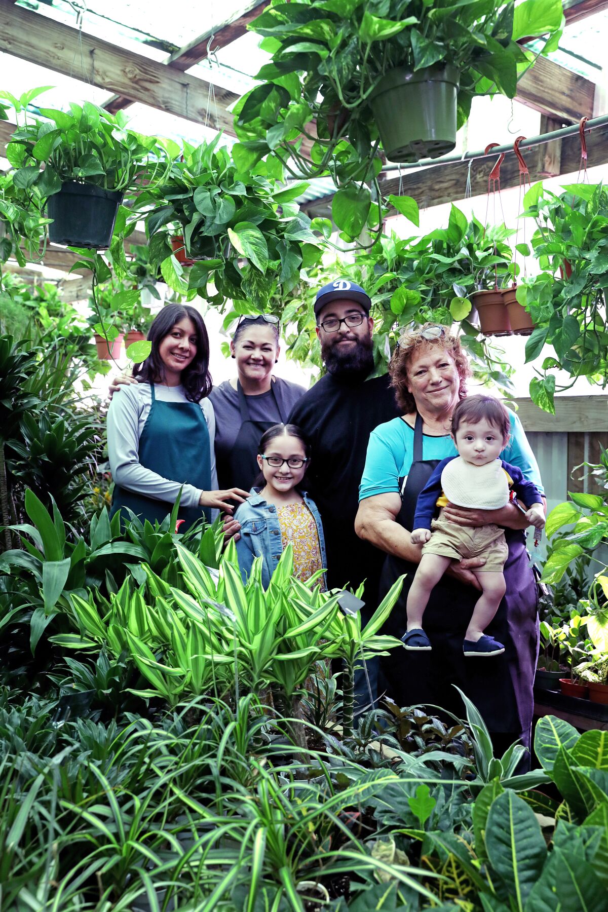 Maria Hurtado Lopez with family members at Avalon Nursery & Ceramics in South Los Angeles.