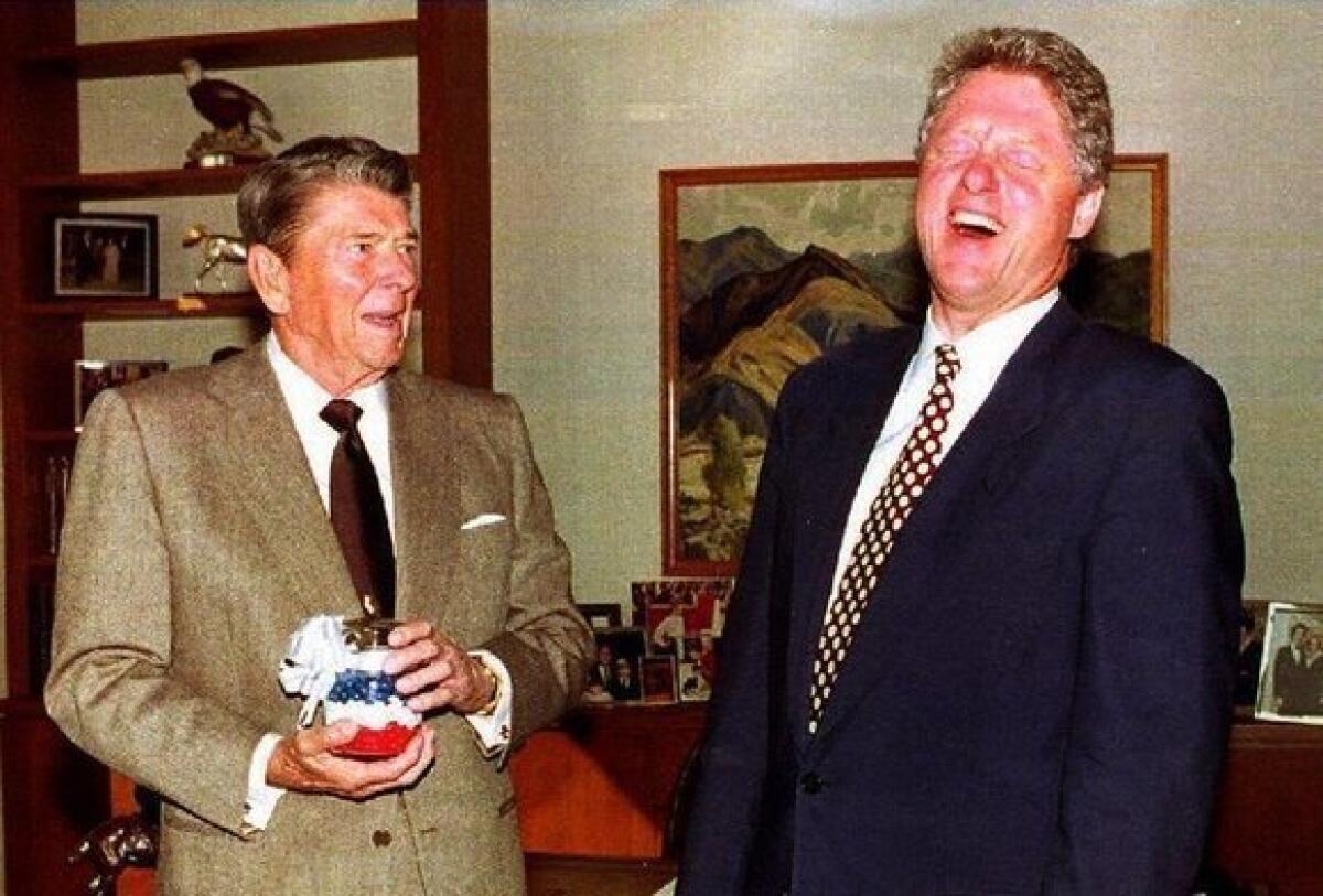 Former President Ronald Reagan presents then-President-elect Clinton with a jar of red, white and blue jelly beans in November 1992.