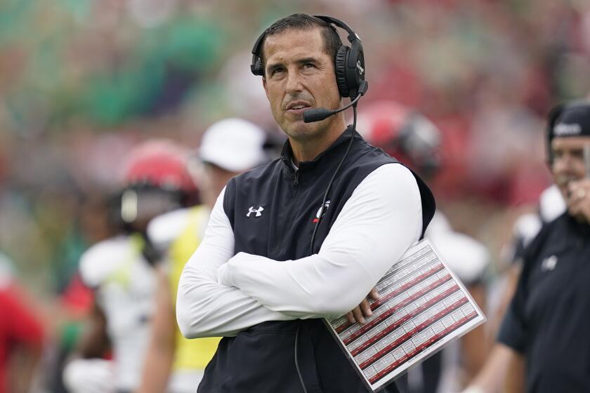 Cincinnati head coach Luke Fickell watches a replay during the first half of an NCAA college football game.