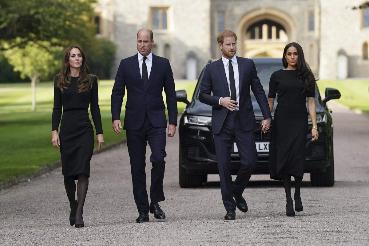 From left, Kate, the Princess of Wales, Prince William, Prince of Wales, Prince Harry and Meghan, Duchess of Sussex walk to meet members of the public at Windsor Castle, following the death of Queen Elizabeth II on Thursday, in Windsor, England, Saturday, Sept. 10, 2022. (Kirsty O'Connor/Pool Photo via AP)