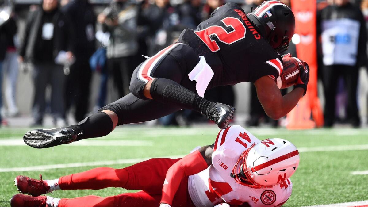 Ohio State running back J.K. Dobbins dives into the end zone on a 10-yard run over Nebraska's Deontai Williams during the first quarter Saturday.