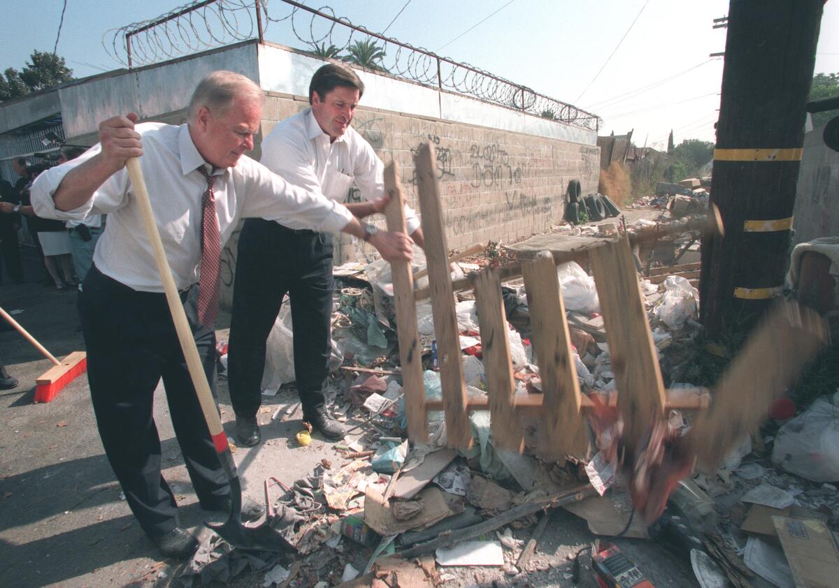 Los Angeles Mayor Richard Riordan and Deputy Secretary of the US Department of the Interior John Garamendi cleanup an alley.