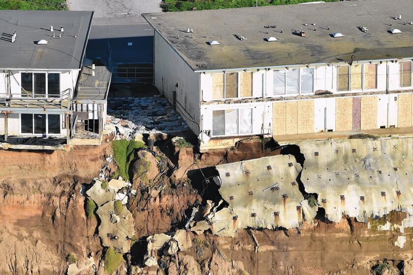 Apartments are seen at the edge of a cliff in Pacifica, Calif. Residents have been forced to evacuate as storms and powerful waves caused by El Niño have been intensifying erosion along coastal bluffs.