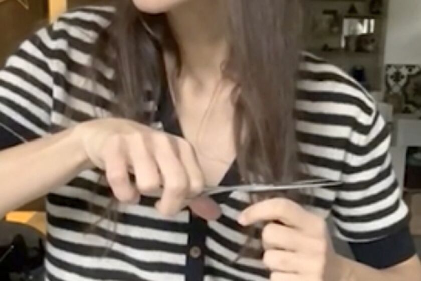 In this image taken from video, Oscar-winning actress Marion Cotillard chops off a lock of her hair to support Iranian protesters standing up to their leadership over the death of Mahsa Amini. Amini, a 22-year-old woman who died in Iran while in police custody, was arrested by Iran's morality police for allegedly violating its strictly-enforced dress code.