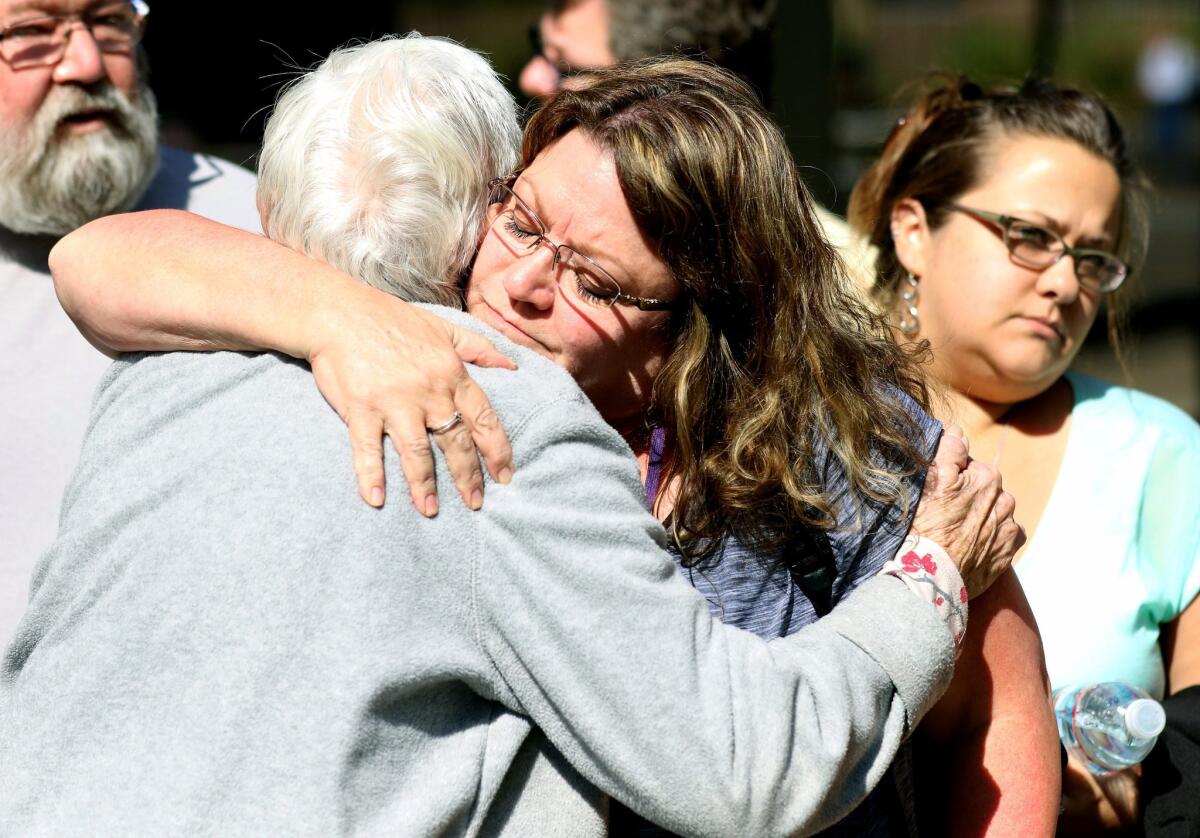 Friends and family are reunited with students at the local fairgrounds after a deadly shooting at Umpqua Community College, in Roseburg, Ore., Thursday, Oct. 1, 2015. (AP Photo/Ryan Kang)