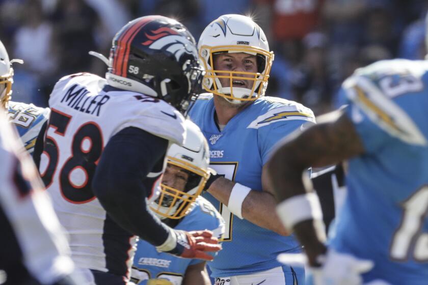 CARSON, CA, SUNDAY, OCTOBER 6, 2019 - Los Angeles Chargers quarterback Philip Rivers (17) drops back to pass as Denver Broncos outside linebacker Von Miller (58) closes in during second half action at Dignity Health Sports Park. (Robert Gauthier/Los Angeles Times)