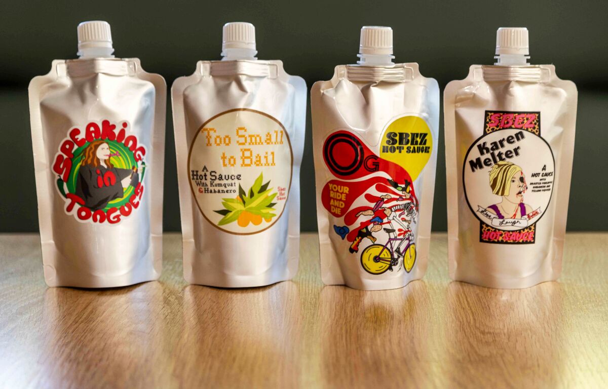 Four bottles of sauces  with colorful labels