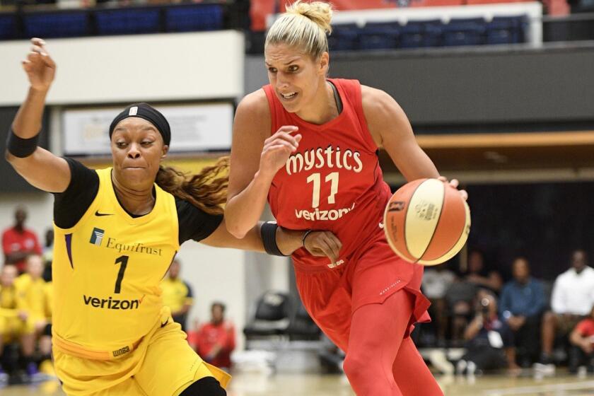 Washington Mystics guard Elena Delle Donne (11) drives to the basket as Los Angeles Sparks guard Odyssey Sims (1) defends during the first half of a single elimination WNBA basketball playoff game Thursday, Aug. 23, 2018, in Washington. (AP Photo/Nick Wass)
