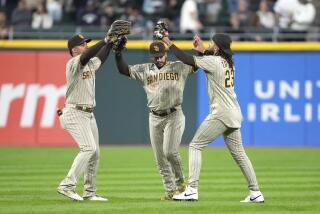 San Diego Padres outfielders Juan Soto, Trent Grisham and Fernando Tatis Jr., from left, celebrate the team's 3-2 win over the Chicago White Sox in a baseball game Friday, Sept. 29, 2023, in Chicago. (AP Photo/Charles Rex Arbogast)