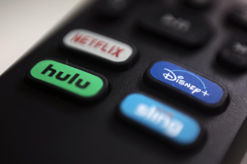 FILE - In this Aug. 13, 2020 file photo, the logos for Netflix, Hulu, Disney Plus and Sling TV are pictured on a remote control in Portland, Ore. As streaming services proliferate, it can be a challenge to keep track of where some favorite TV shows and blockbuster movies are available. (AP Photo/Jenny Kane)