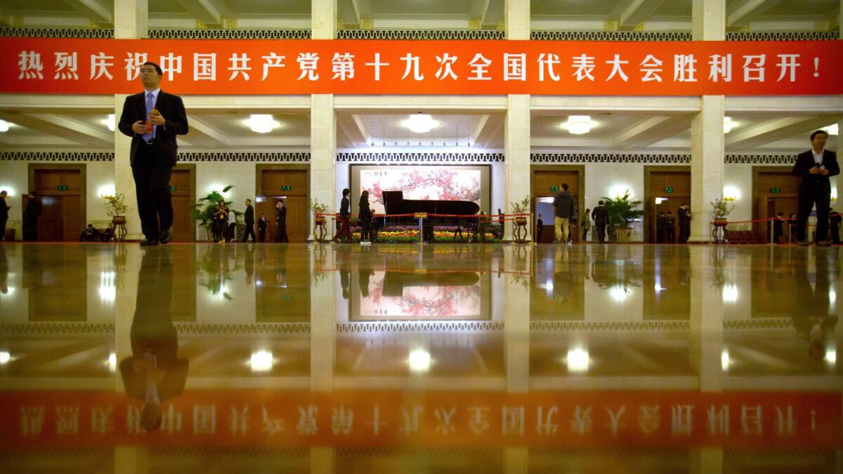 Attendees walk through the lobby of the Great Hall of the People during the closing ceremony of China's 19th Party Congress in Beijing on Oct. 24.