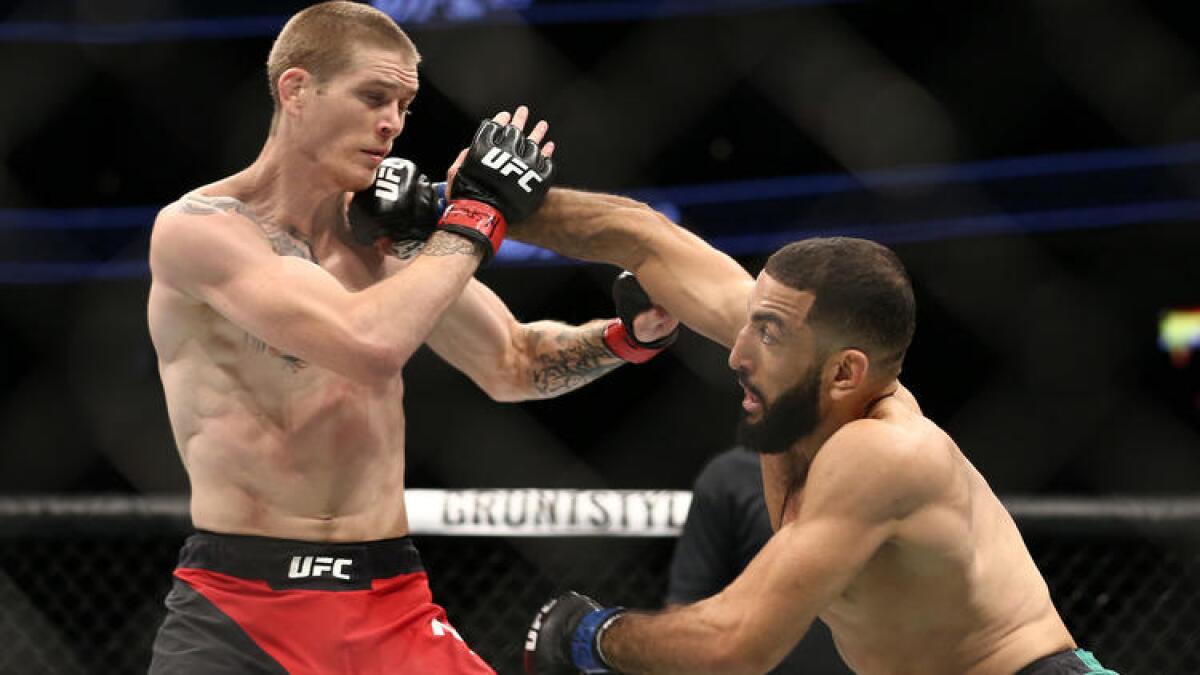 Belal Muhammad strikes Jordan Mein with an overhand right during their welterweight bout at UFC 213.