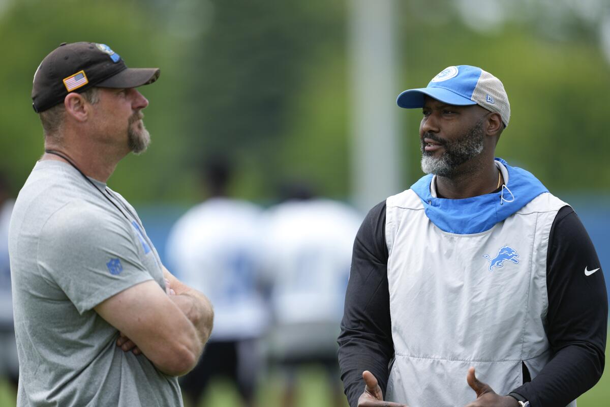 Detroit Lions head coach Dan Campbell, left, and general manager Brad Holmes talk during practice.