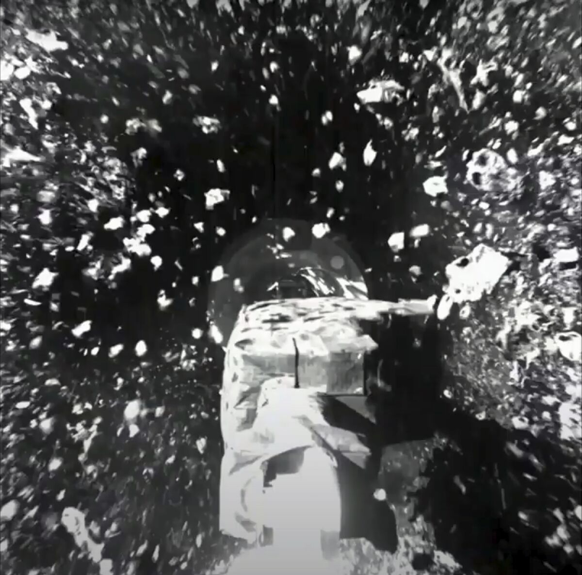Rocks kicked up by a spacecraft arm
