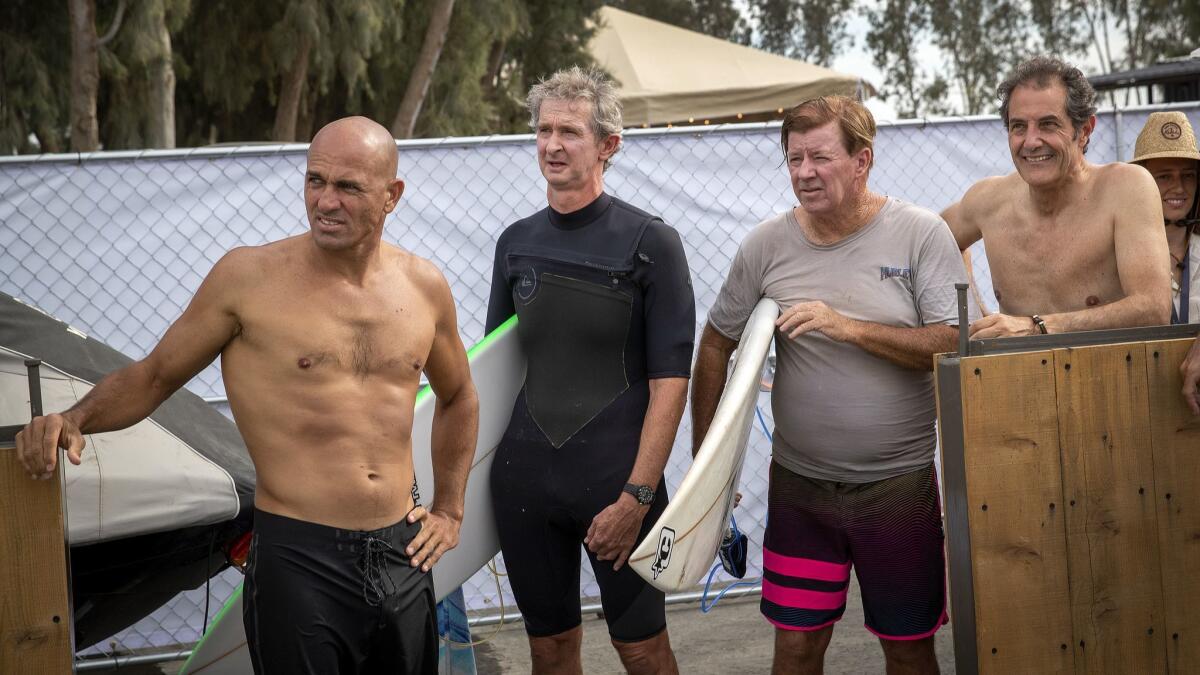 From left: Kelly Slater, 11-time world champion, Mark Richards, a four-time world champion from Australia, Wayne "Rabbit" Bartholomew, a three-time world champion from Australia, and Shaun Tomson, a world champion from South Africa, wait for their turn to surf.