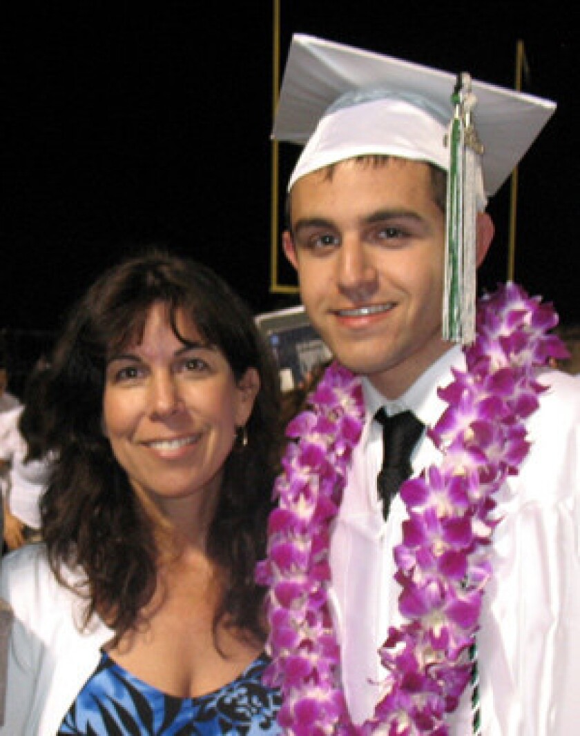 Carol Champommier and her son, Zachary, at his high school graduation in 2010, three weeks before he was killed by law enforcement officers in a Studio City parking lot.