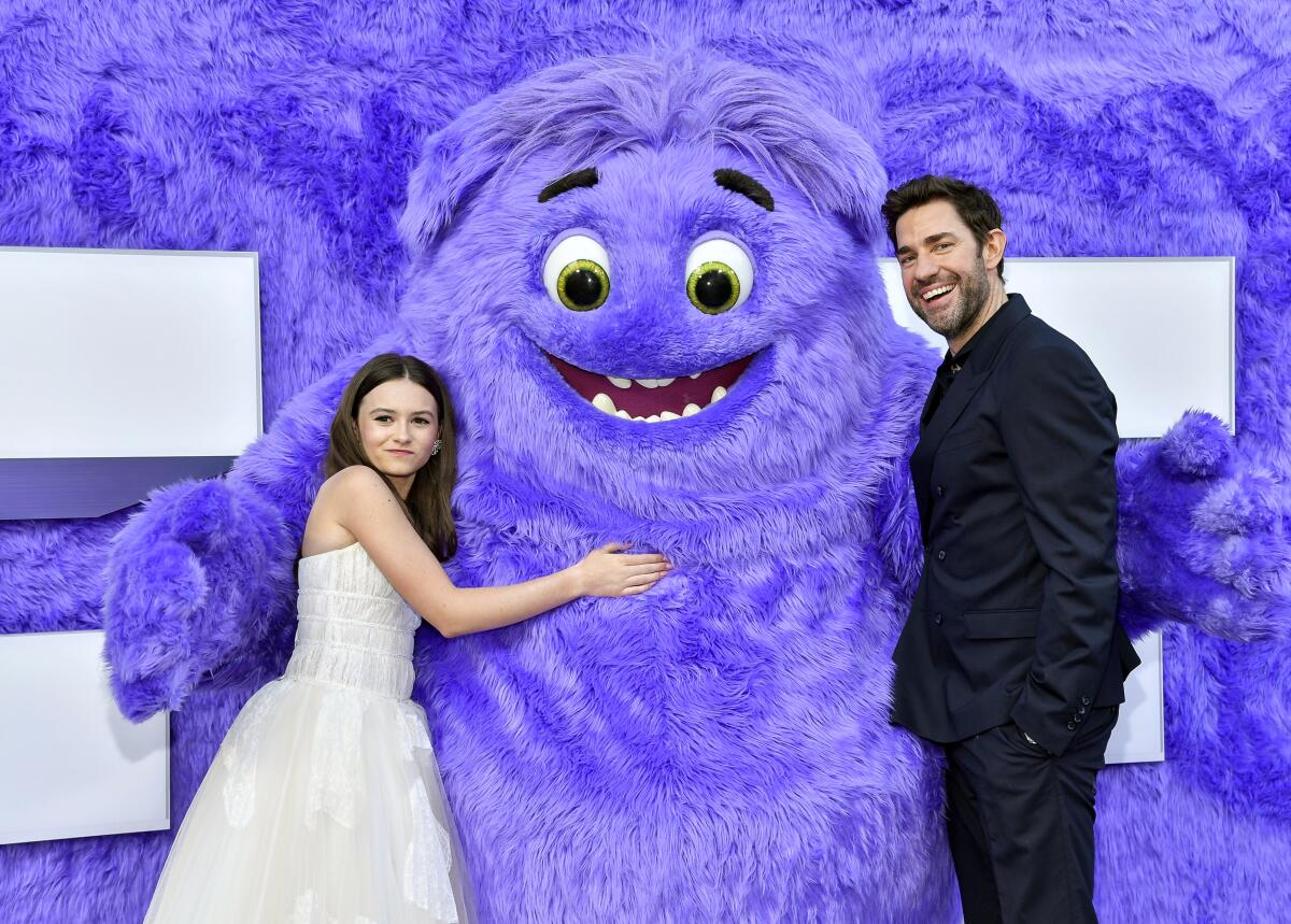 Cailey Fleming and John Krasinski with the furry character Blue.