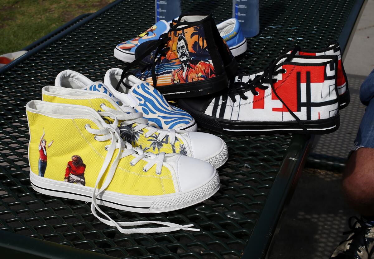 Several Alma Laguna shoes are displayed on a table in Heisler Park on Thursday in Laguna Beach.