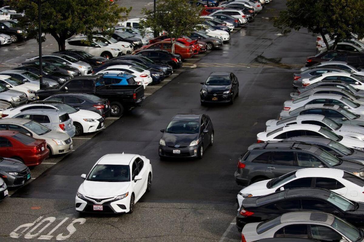 Drivers look for parking spots at Cal State L.A. The university has partly closed two large parking lots because of construction projects, resulting in the temporary loss of about 1,200 spaces over the last year.